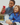 Two kids sitting outdoors taking a photo with a red Xplora phone.