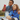 Two kids sitting outdoors taking a photo with a red Xplora phone.